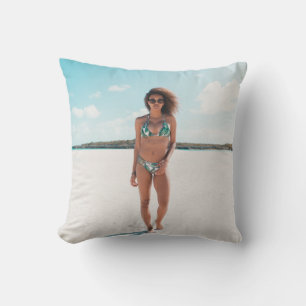 Woman wearing bikini standing on sand throw pillow