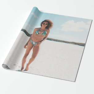 Woman wearing bikini standing on sand wrapping paper