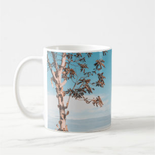 Woman wearing black bikini tap swimming on body of coffee mug