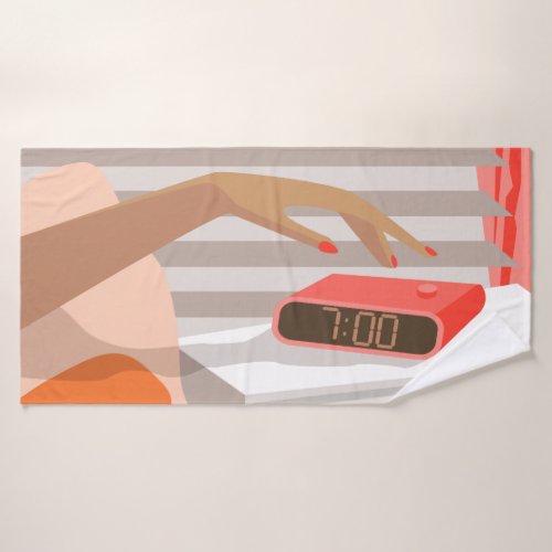 Womans hand pushing on alarm clock snooze button bath towel