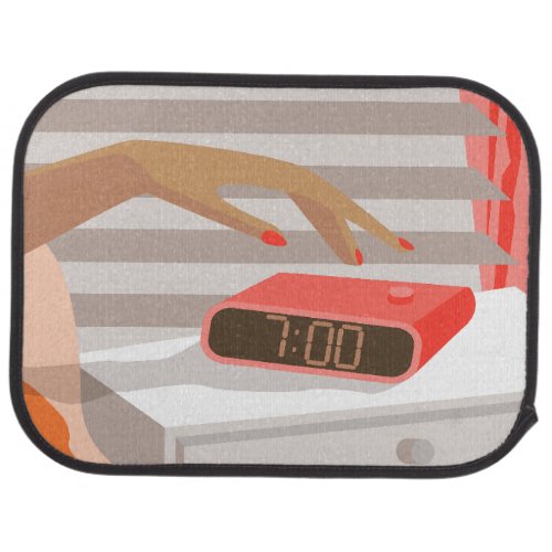 Womans hand pushing on alarm clock snooze button car floor mat
