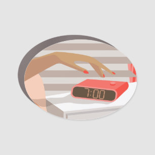 Womans hand pushing on alarm clock snooze button car magnet