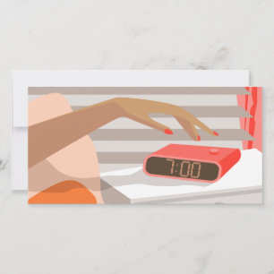 Womans hand pushing on alarm clock snooze button holiday card