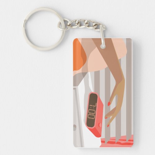 Womans hand pushing on alarm clock snooze button keychain