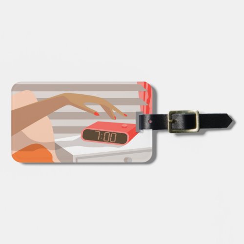 Womans hand pushing on alarm clock snooze button luggage tag