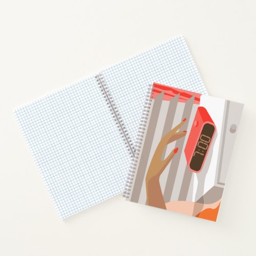 Womans hand pushing on alarm clock snooze button notebook