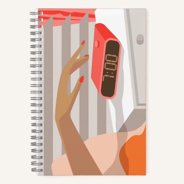 Womans hand pushing on alarm clock snooze button notebook (Front)