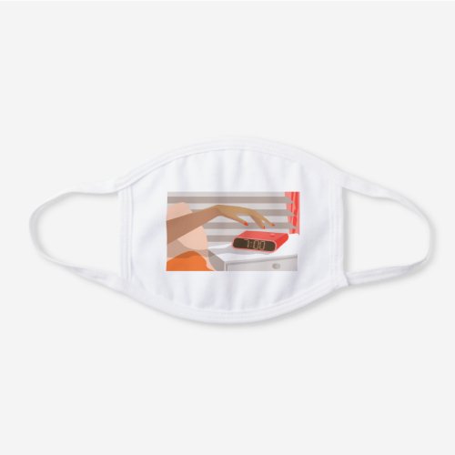 Womans hand pushing on alarm clock snooze button white cotton face mask