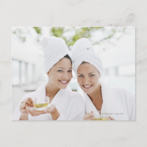 Women in bathrobes drinking tea at spa postcard