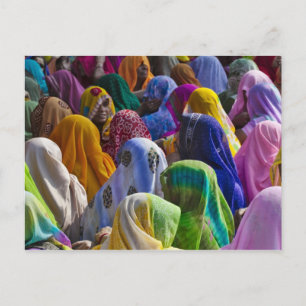 Women in colorful saris gather together postcard
