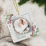 Wood Cranberry Foliage Baby First Christmas Photo Ceramic Ornament<br><div class="desc">A beautiful festive baby's first Christmas ornament. Our design features our beautiful watercolor cranberry festive greenery framing the corners of the ornament. Faux white shiplap wood backgrpound. Customize with your photo,  year,  and name. Design by Moodthology Papery</div>