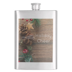 wooden background with pine cones flask