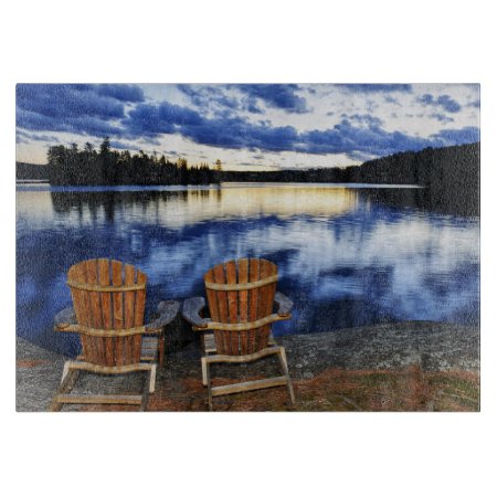 Wooden Chairs At Sunset On Lake Shore Cutting Board