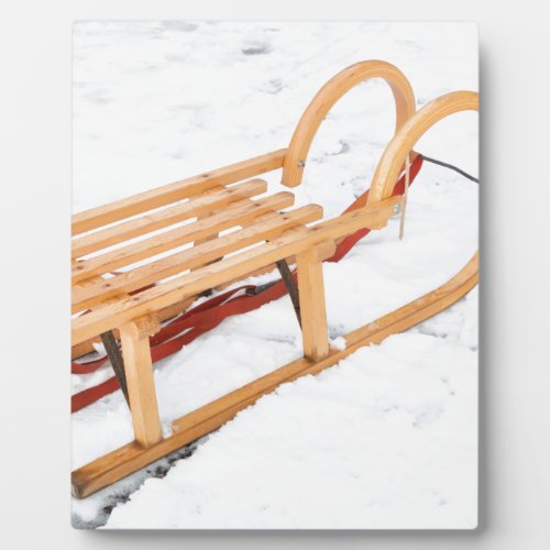 Wooden children sled in winter snow plaque