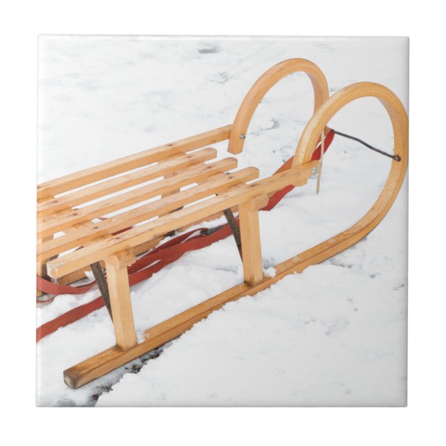 Wooden children sled in winter snow tile (Front)