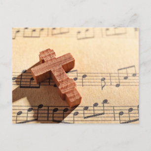 Wooden cross on sheet music paper postcard