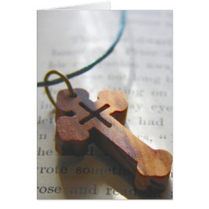 Wooden Cross Still Life on Vintage Book Page