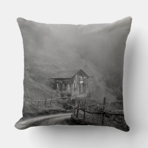 Wooden hut in nature/fog at mountain throw pillow