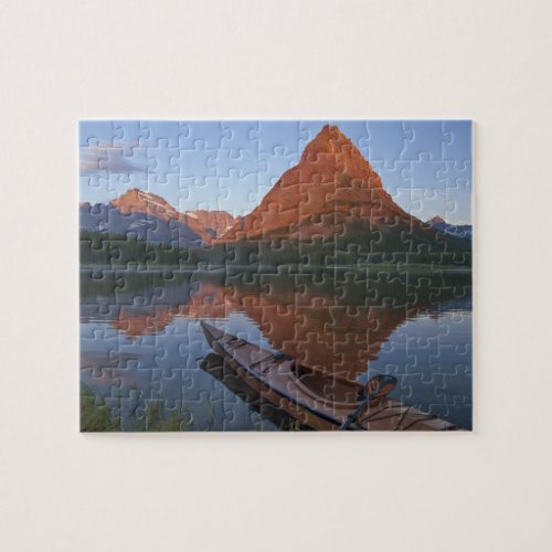 Wooden kayak in Swiftcurrent Lake at sunrise in Jigsaw Puzzle