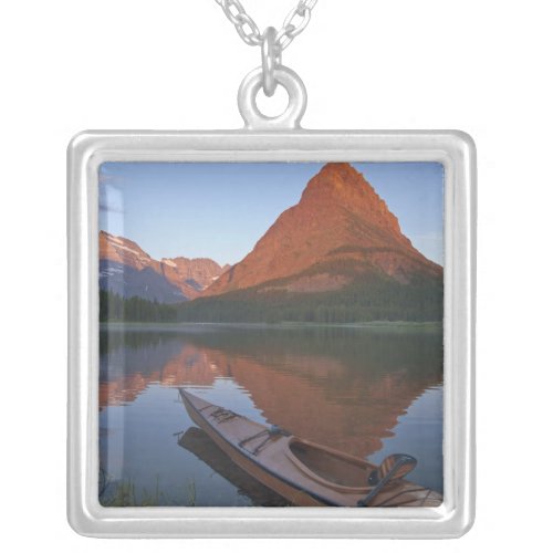 Wooden kayak in Swiftcurrent Lake at sunrise in Silver Plated Necklace
