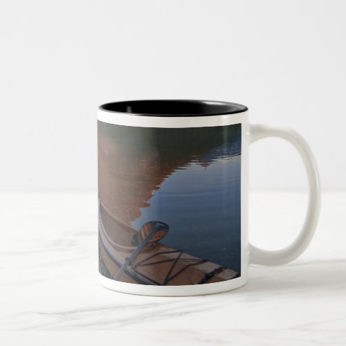 Wooden kayak in Swiftcurrent Lake at sunrise in Two_Tone Coffee Mug