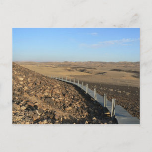 Wooden road leading to a hill peak postcard