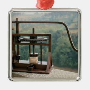 Working model of an olive press metal ornament