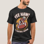Yee Haw! It’s Football Season! T-Shirt<br><div class="desc">Kick off the season with a fun twist on football! This eye-catching tee features a cartoon football player riding a giant football like a rodeo cowboy, complete with the bold text: “Yee Haw! It’s Football Season!”. Perfect for fans who love both the excitement of the game and a little humor....</div>