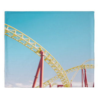 Yellow and red roller coaster under blue sky at da duvet cover
