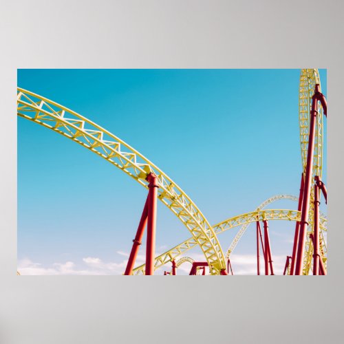 Yellow and red roller coaster under blue sky at da poster