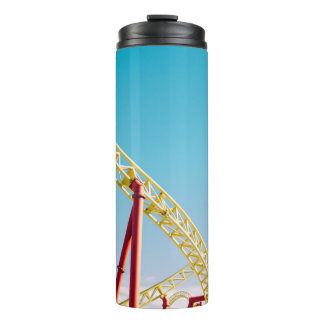 Yellow and red roller coaster under blue sky at da thermal tumbler