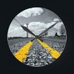 Yellow Asphalt Highway Road Creative Photography Round Clock<br><div class="desc">This selective yellow color captivating black and white image features a long, empty road. The bold yellow lines in the center of the road divide the image into two distinct sections, creating a sense of balance and order. The lack of color adds a touch of mystery and intrigue, while the...</div>
