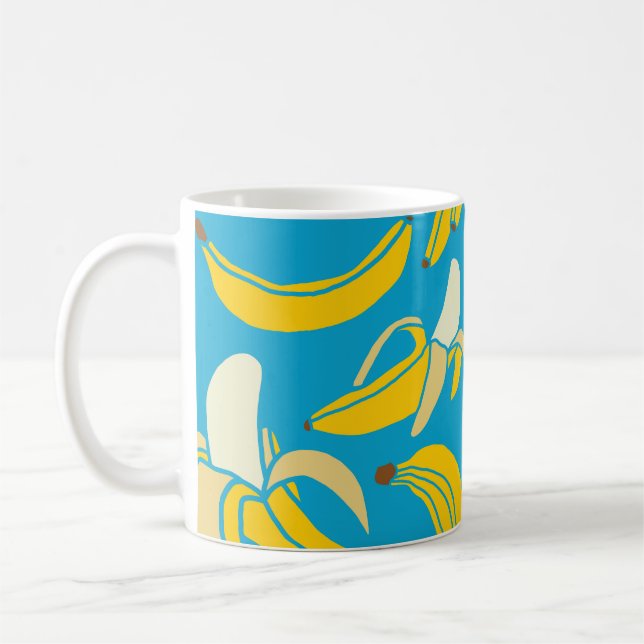 Yellow bananas, blue background pattern coffee mug (Left)