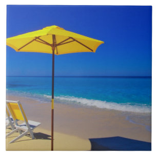 Yellow beach umbrella and chairs on pristine ceramic tile