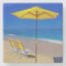 Yellow beach umbrella and chairs on pristine