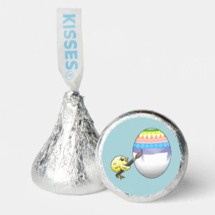 Yellow chick paints a colorful Easter egg Hershey®'s Kisses®