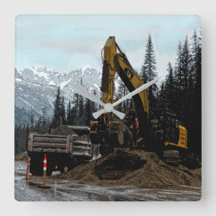 Yellow Excavator and Mountains Wall Clock