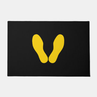 YELLOW FOOTPRINTS ON BLACK DOORMAT