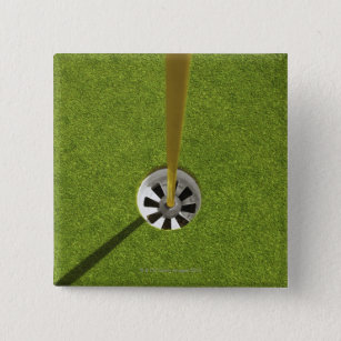 Yellow golf flag pole and hole button