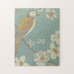 Yellow, Grey and Beige Bird Perched on a Branch Jigsaw Puzzle<br><div class="desc">Chariklia Zarris is known for her abstract art pieces. In this drawing of a profile of a bird on a blue teal background,  she captured the simplicity of the bird. The white flowers add a romantic touch. Customize your favorite Zazzle product using this beautiful image.</div>