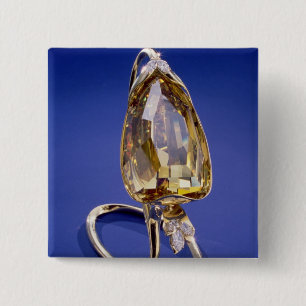 Yellow 'Incomparable' diamond in a gold setting Button