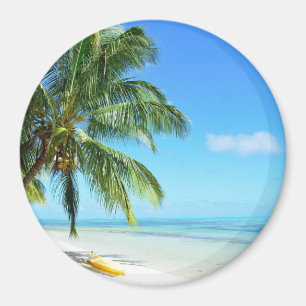 Yellow kayak on a white sand beach round magnet