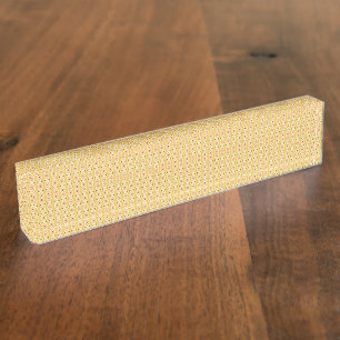 Yellow, orange, and brown sheets of wrapping paper desk name plate