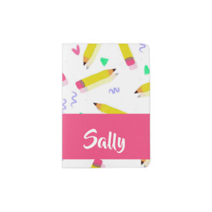Yellow pencils and scrabbles on white passport holder