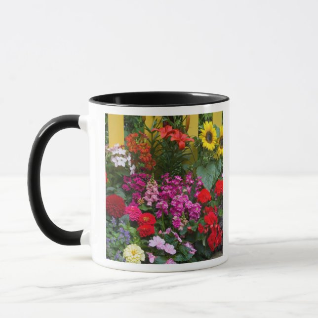 Yellow picket fence with flower garden in mug (Left)
