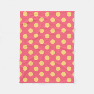 Yellow polka dots on coral fleece blanket