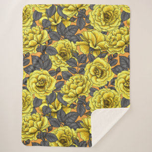 Yellow roses with gray leaves on orange sherpa blanket