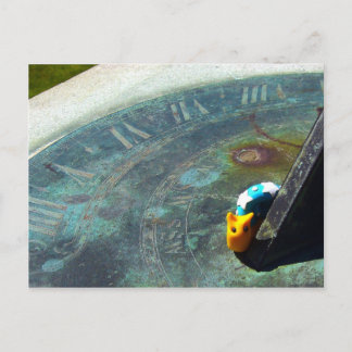 Yellow snail visiting a sundial postcard
