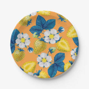 Yellow strawberries on orange paper plates