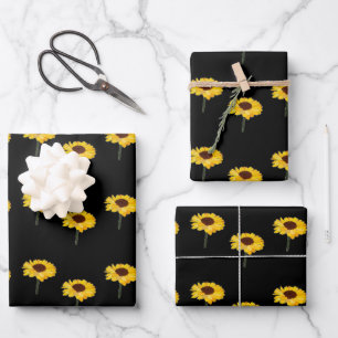 Yellow sunflowers on black wrapping paper sheets